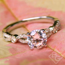 Load image into Gallery viewer, Kirk Kara White Gold &quot;Lori&quot; Vintage Style Twist Diamond Engagement Ring Angled Front View with Floral Background
